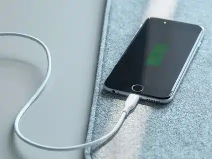 iPhone charging with Lightning cable plugged in.