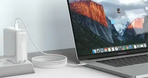 MacBook Pro laptop charging with USB C cable.