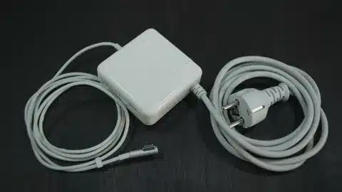 “Older Apple MagSafe 2 charger showing integrated cable and AC power plug”