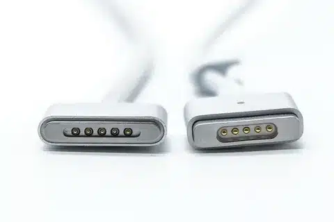“Photo showing MagSafe 2 connector next to original MagSafe with visible pin size difference”