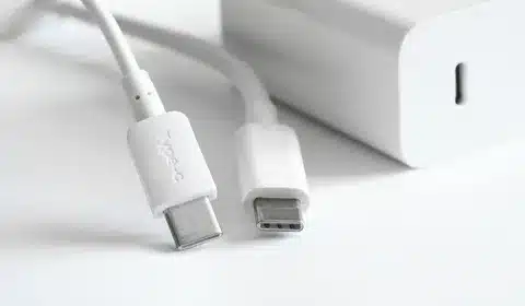 Close-up view of two USB Type-C cables next to a white charging adapter
