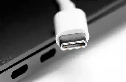 White USB Type C cable connected to modern laptop port