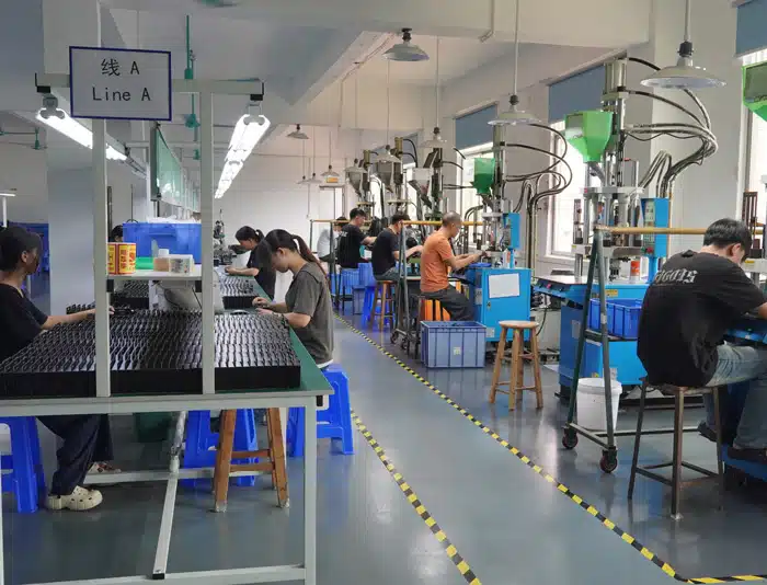 Workers assembling custom cables on production line at Kingda Cables factory