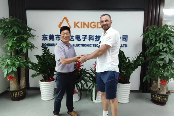 Kingda Cables team representative shaking hands with international client to strengthen business partnership