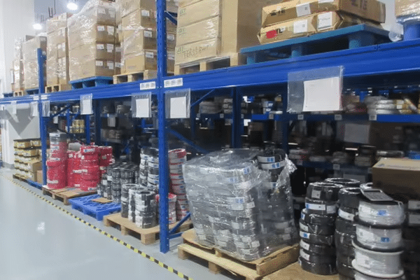 Organized warehouse inventory of custom cables and packaged goods at Kingda Cables factory