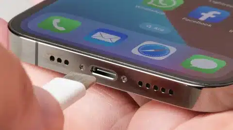 close-up of smartphone with USB-C cable being plugged into charging port