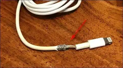 broken iPhone lightning cable showing visible damage near connector