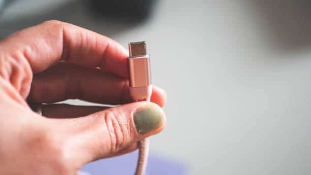 Hand holding USB-C cable for testing speed and charging quality