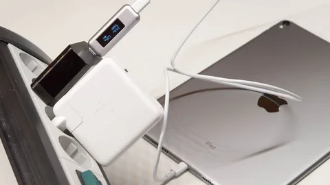iPad Pro with USB-C cable and Apple power adapter charging on power strip