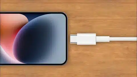 iPhone 15 connected to USB-C cable while charging on desk