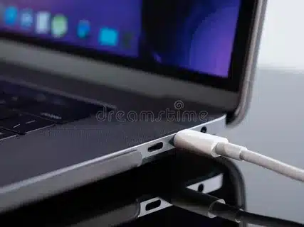 close-up of laptop charging through USB-C cable
