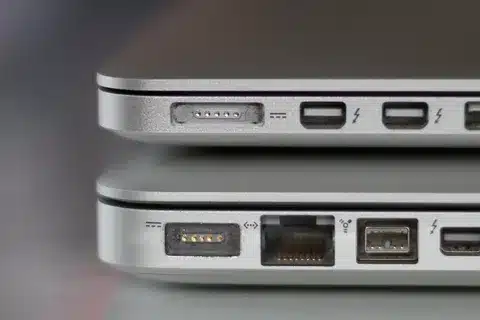 MacBook showing different MagSafe charging ports on older and newer models