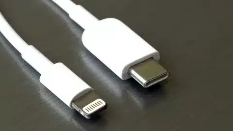 white USB-C to Lightning cable ends placed on metallic surface