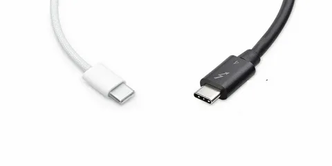 white USB-C cable next to black Thunderbolt cable for comparison