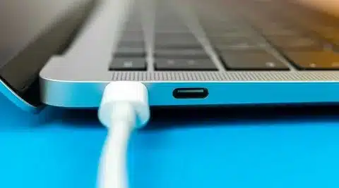 close-up of laptop USB-C charging port with cable connected