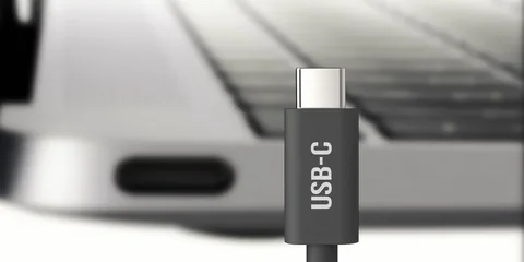 USB-C charging cable in front of laptop with USB-C port