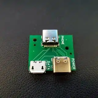 close-up of USB-C port on green circuit board used in smartphones
