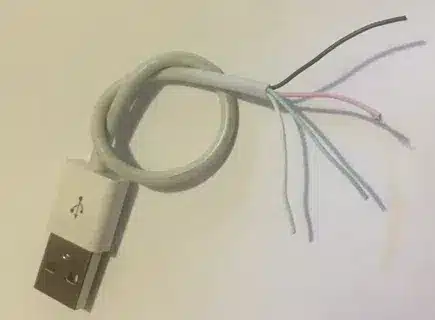 Stripped USB cable showing four wires prepared for connecting