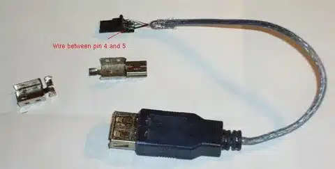 opened USB cable showing wire between pin 4 and 5 with connector parts